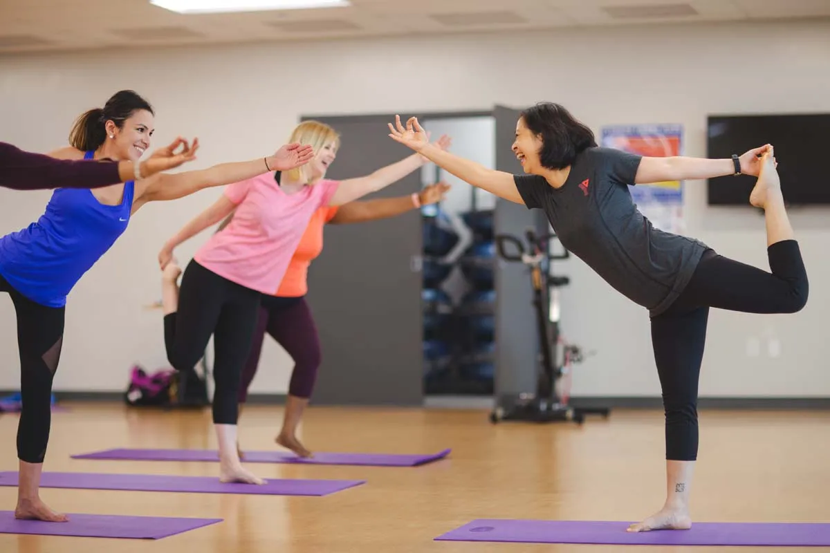 A YMCA volunteer leads a yoga class