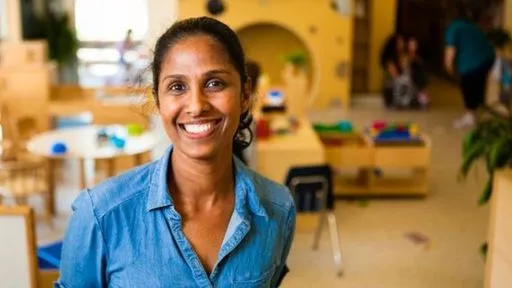 A smiling staff member at a YMCA child care location