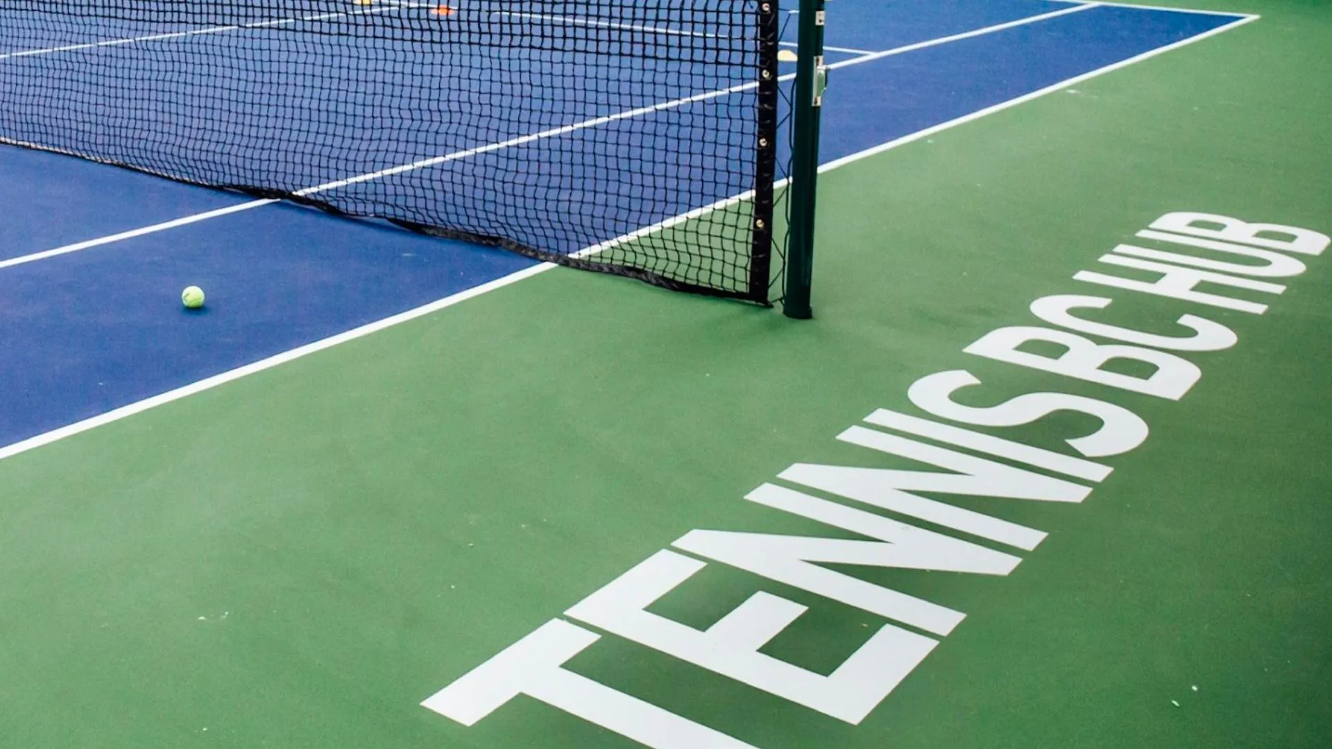 A tennis court branded for Tennis BC, a YMCA partner