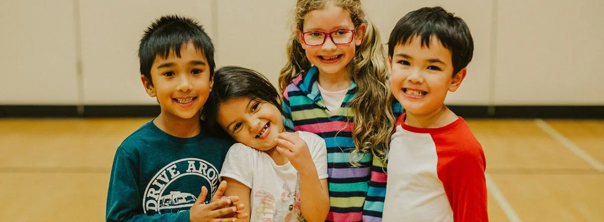 A group of four children participating in a child, youth, and family program at the Robert Lee YMCA