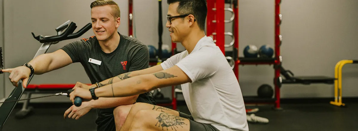 A member being coached by a YMCA Personal Trainer at the Robert Lee YMCA gym in Vancouver