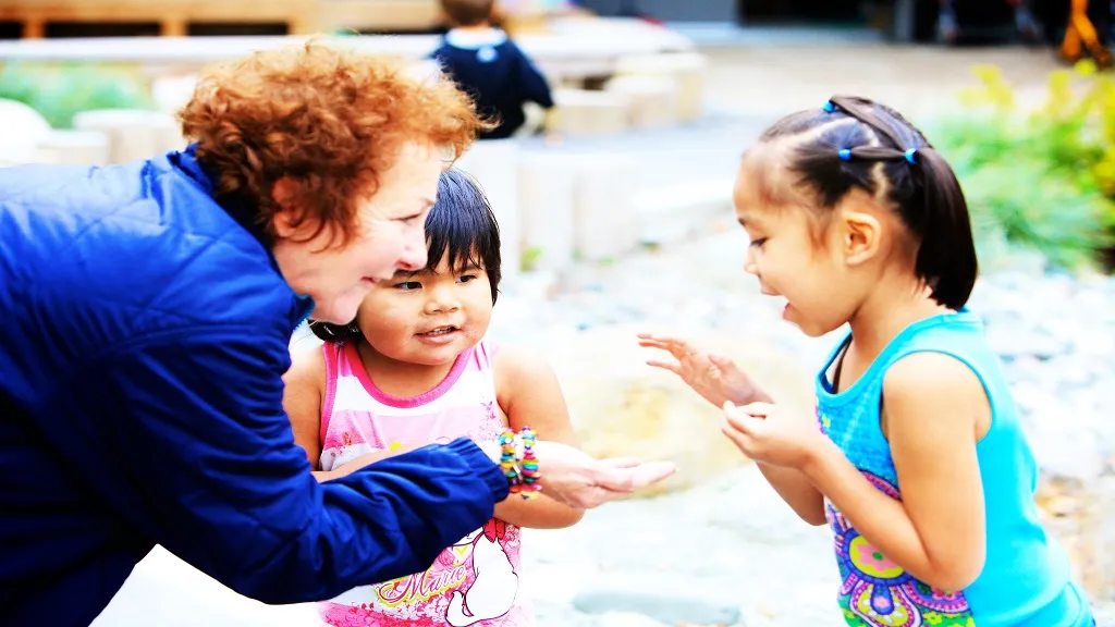 Caregiver showing something to child