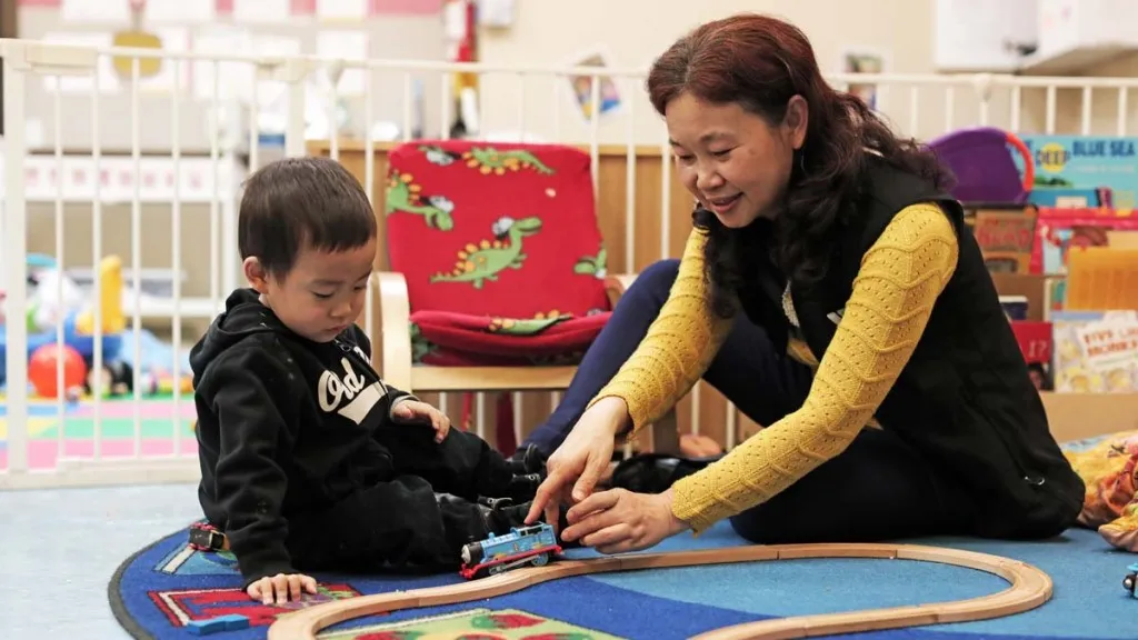 Woman playing trains with a child