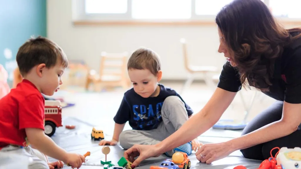 Child care provider playing with children