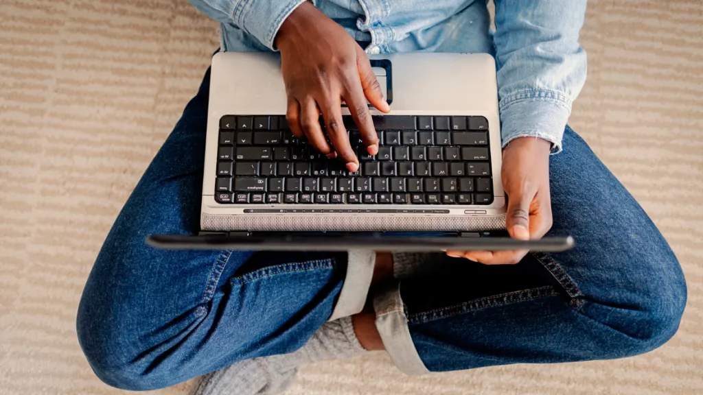 Person sitting with a laptop