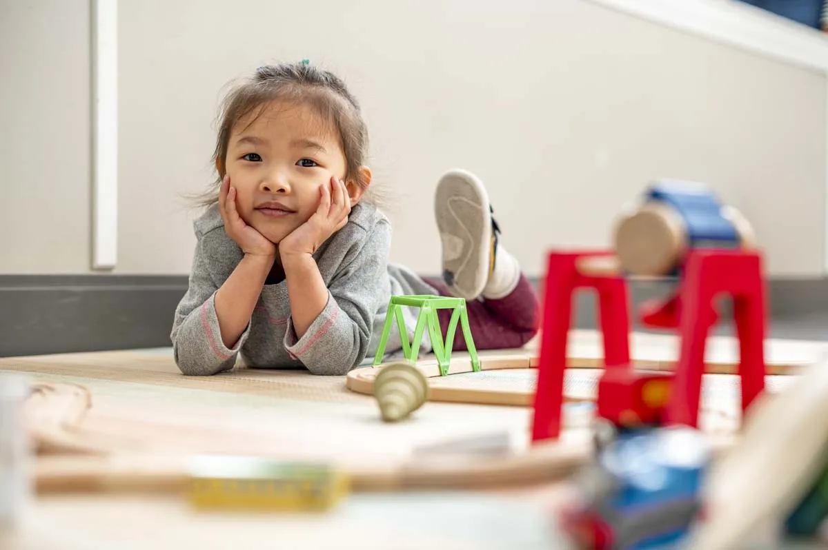 Child laying on the floor of a child care