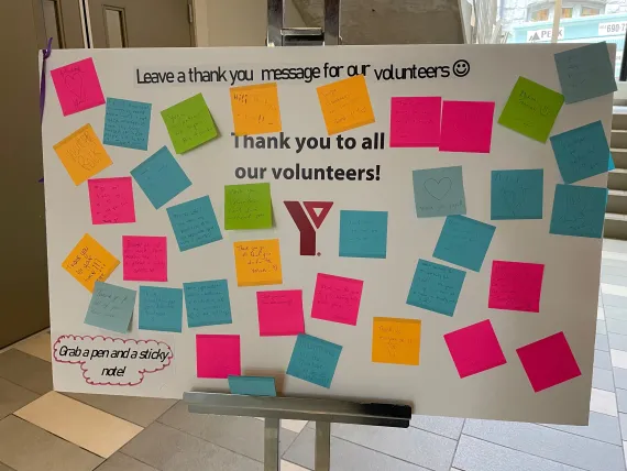 A poster board at Robert Lee YMCA is covered in post-it notes with thank-you messages to volunteers.