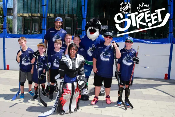 A street hockey team of preteens wearing Vancouver Canucks shirts