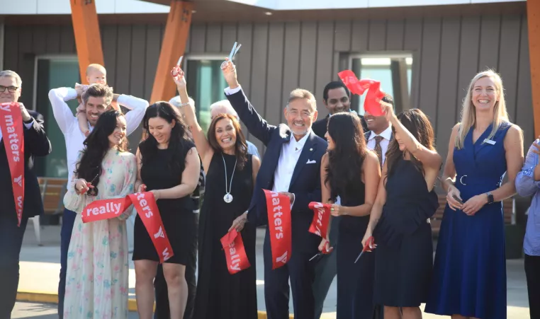 Bob Chan-Kent and family members celebrate after cutting the ribbon on the newly renamed Bob Chan-Kent Family YMCA.