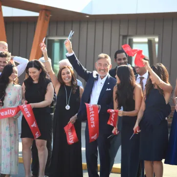 Bob Chan-Kent and family members celebrate after cutting the ribbon on the newly renamed Bob Chan-Kent Family YMCA.