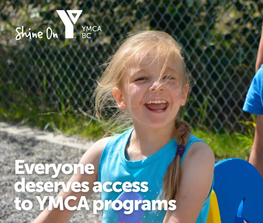 A smiling young girl at an outdoor playground. Text on the image reads: "Everyone deserves access to YMCA programs"