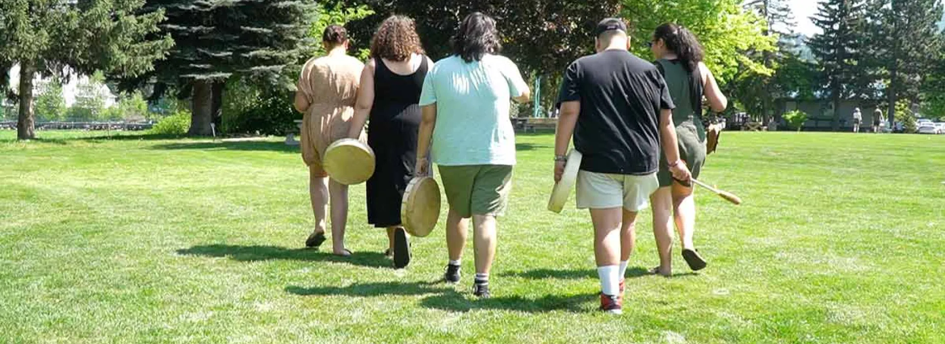 Indigenous Mind Medicine mental wellness program participants walking with drums