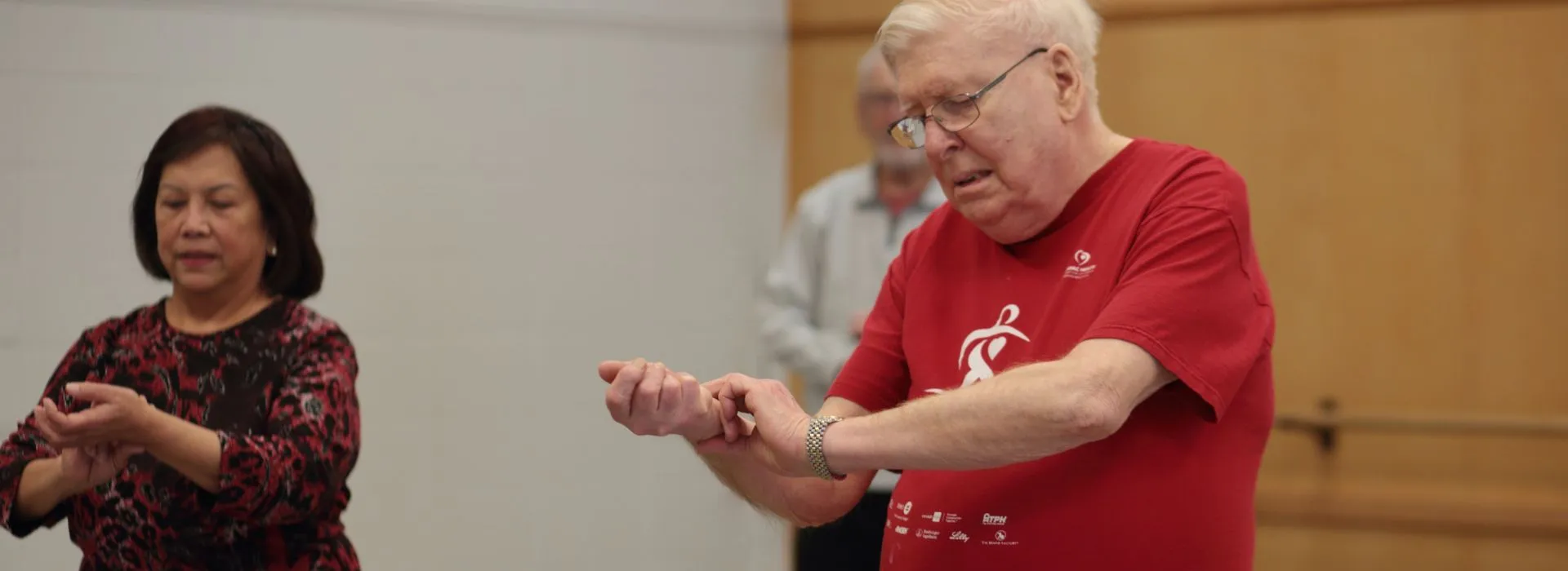 YMCA Healthy Heart participants checking their heart rate in group exercise class